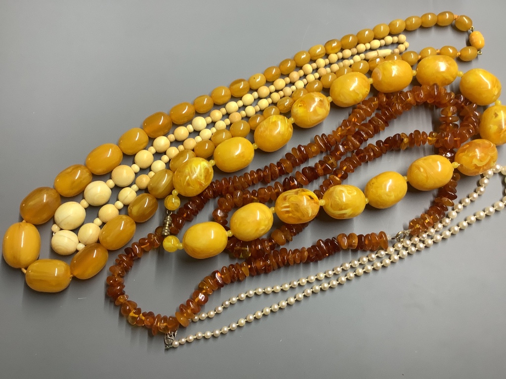 A single strand graduated cultured pearl necklace with rose cut diamond set 9 carat white gold class, 48 cm an amber necklace and three other necklaces.